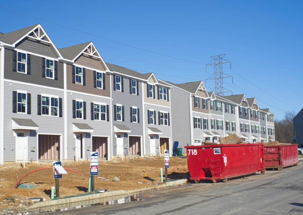 A North Carolina suburban street with single-family homes and empty lots, suggesting growth pressure on housing supply.